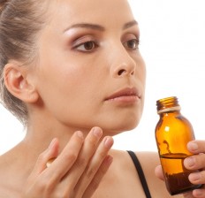 woman-smelling-bottle-isolated-on-white-background-232x224